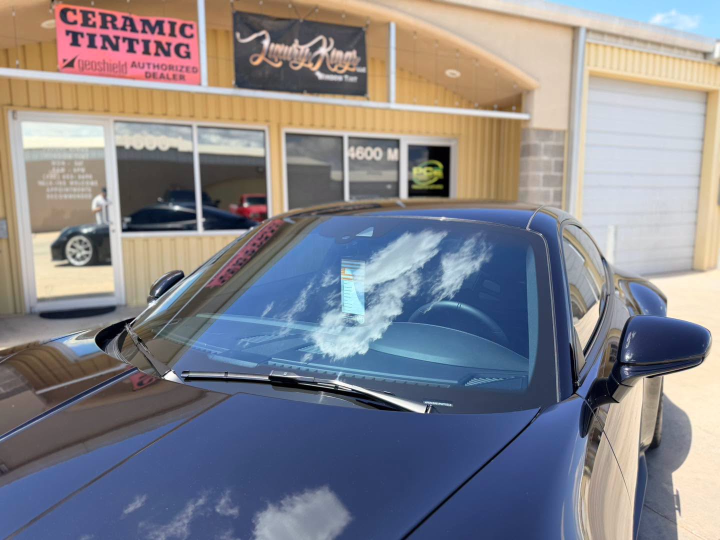 GT3 windshield reflecting clouds in front of the shop